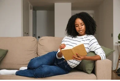 Young lady reading a book to boost cognitive health and prevent dementia.
